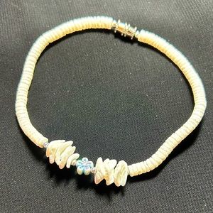 VTG White Puka shell bracelet with barrel clasp and cute blue flower accent.